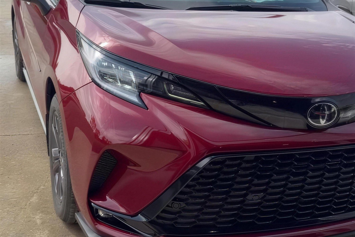 Red Toyota Sienna with the front bumper, headlight and fender fully restored after repair at Lankford Paint & Body