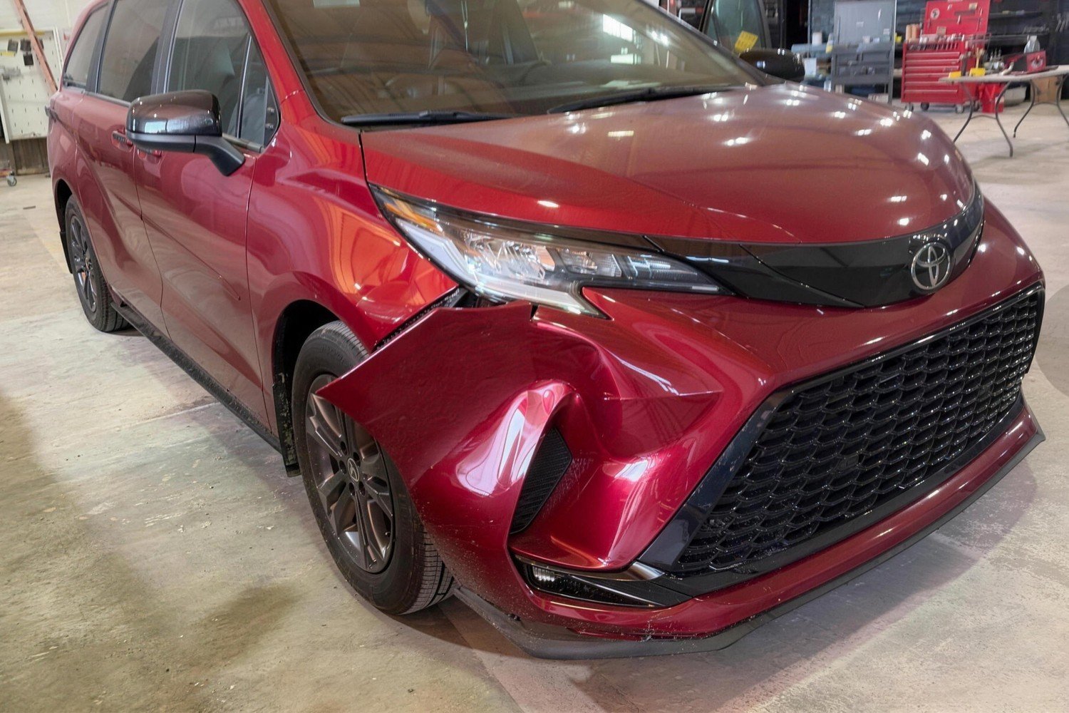 Red Toyota Sienna with a crushed front bumper, broken headlight and crumpled fender, before repair at Lankford Paint & Body